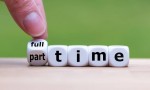 Hand is turning a dice and changes the word "full-time" to "part-time" (or vice versa).